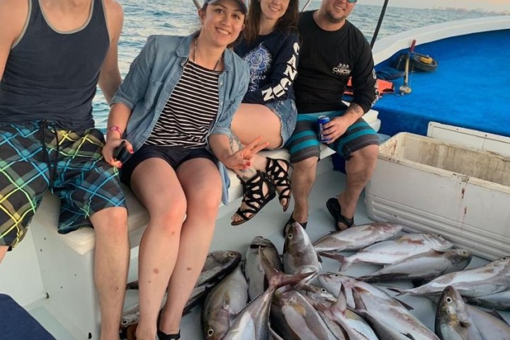 a person holding a fish on a boat