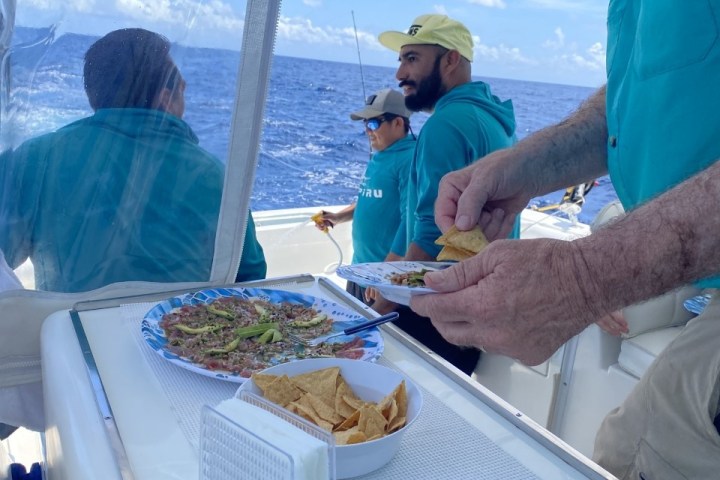 a group of people preparing food in a boat