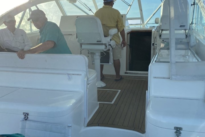 a group of people sitting around a plane