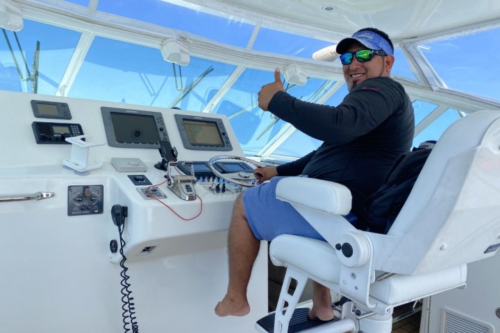 a man sitting on a boat in Cancun