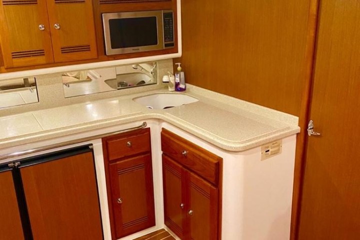 a kitchen with wooden cabinets and a microwave