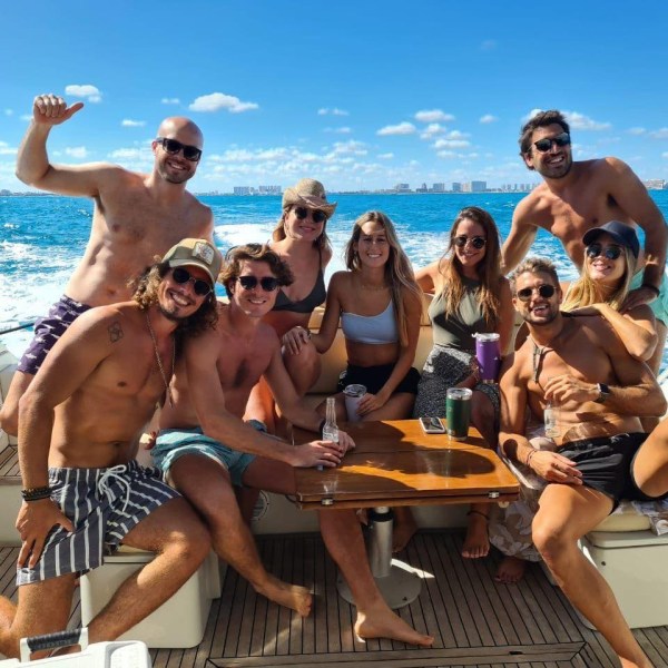 a group of people standing next to a body of water