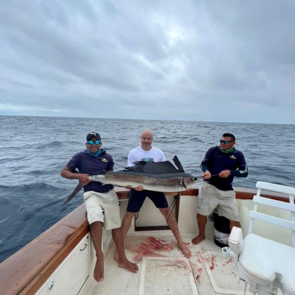 a group of people in a boat on a body of water