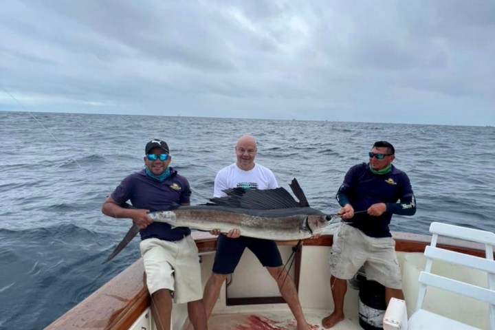 a group of people in a boat on a body of water
