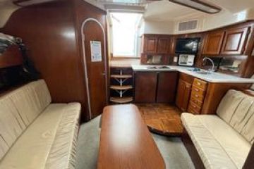 a bedroom with a bed and a chair in a room