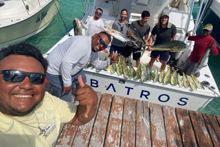 a group of people sitting at a dock