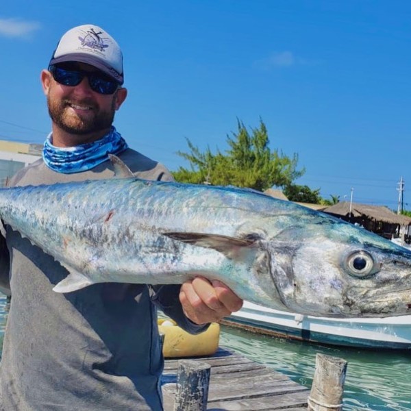 a man holding a fish
