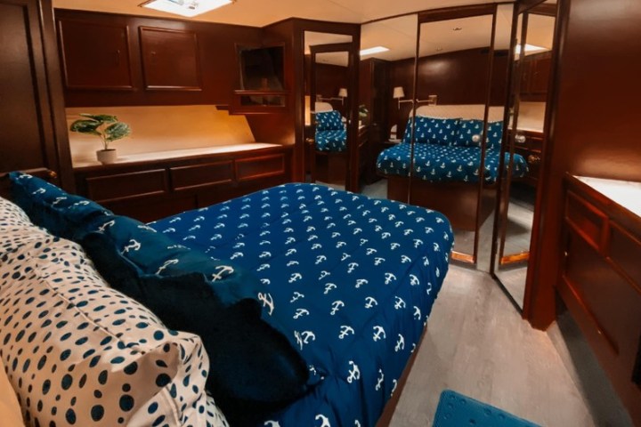 a bedroom with a bed and desk in a room