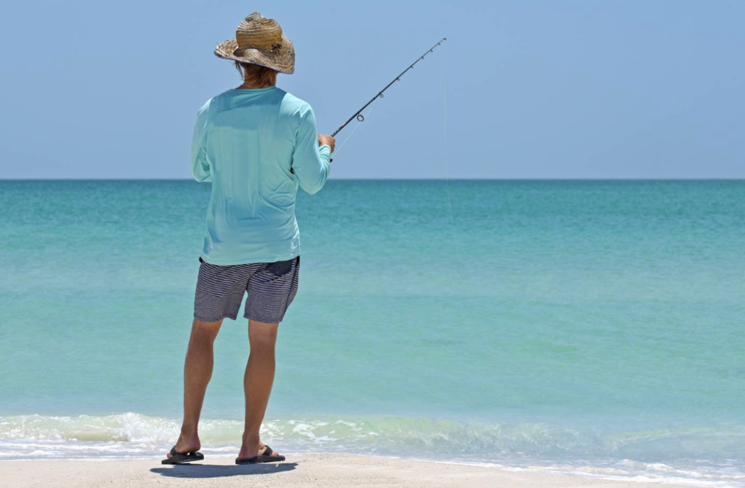 a man standing next to a body of water