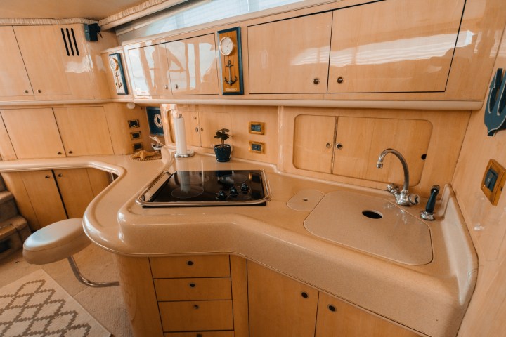 a stove top oven sitting next to a sink