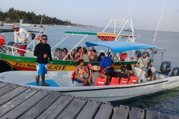 a group of people on a boat in the water