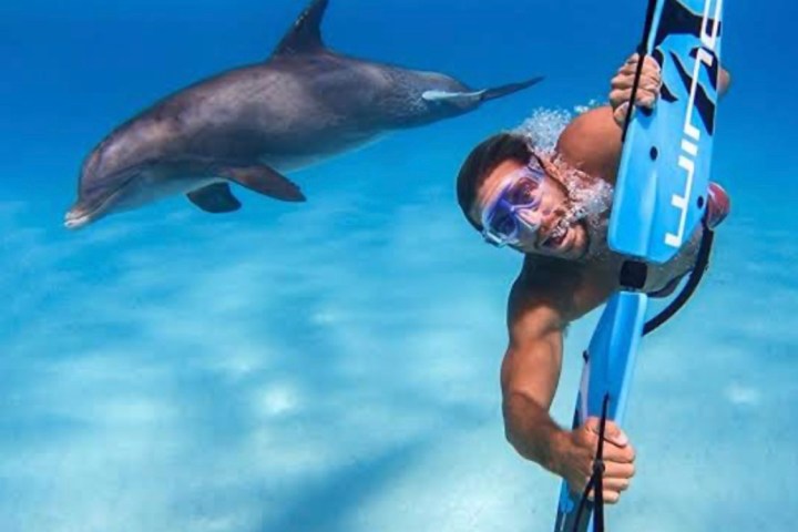 a man flying through the blue water