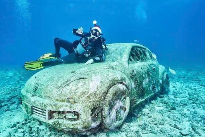 a man riding a motorcycle down a dirt road