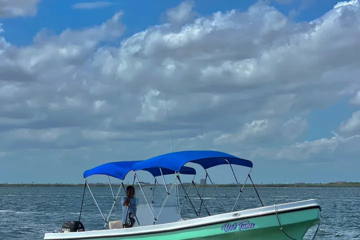 a boat sitting on top of a blue cloudy sky