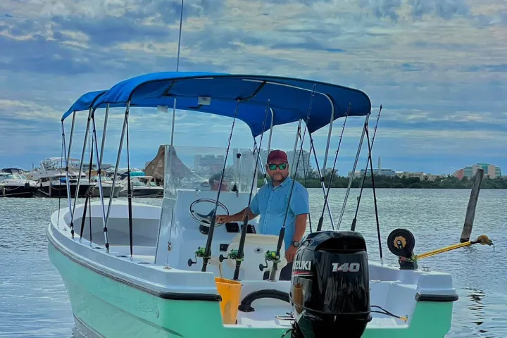 a green boat on a body of water